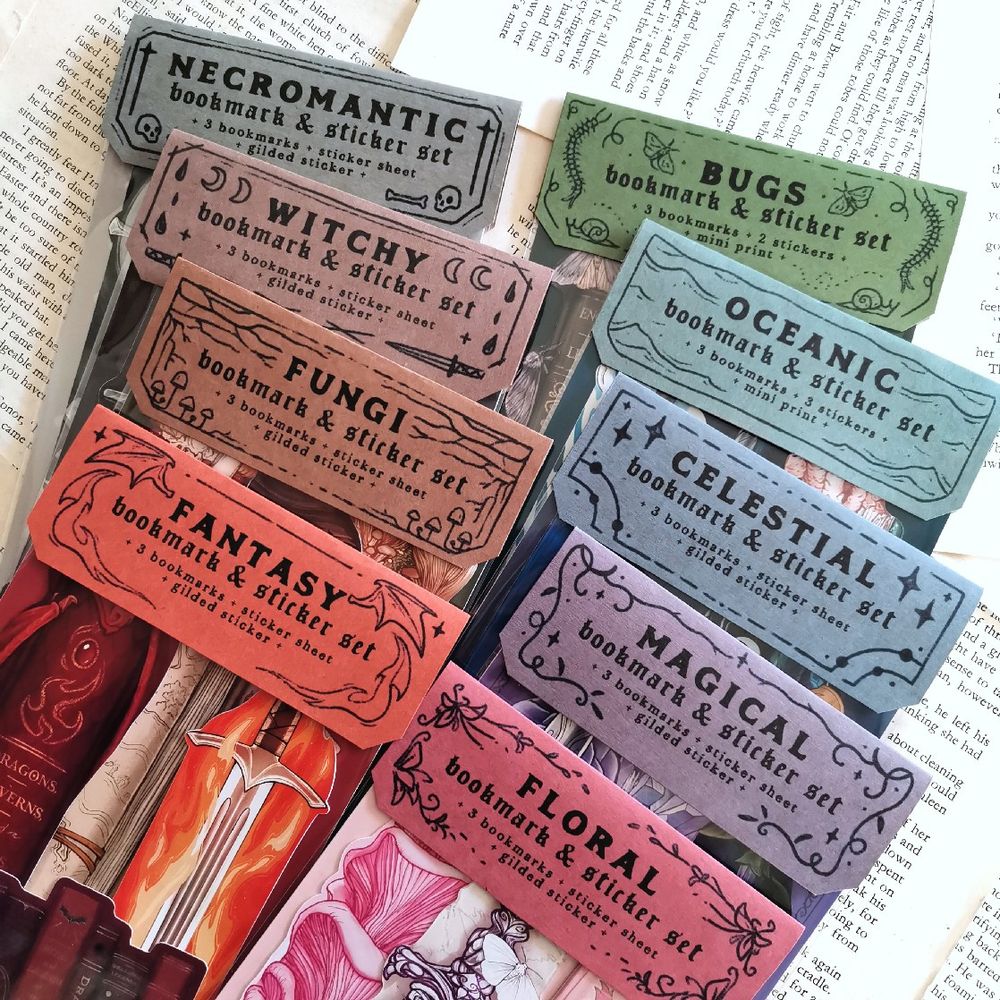 photo of the top label of the art packs layered over each other, the titles are: necromantic, bugs, witchy, oceanic, fungi, celestial, fantasy, magical, floral.