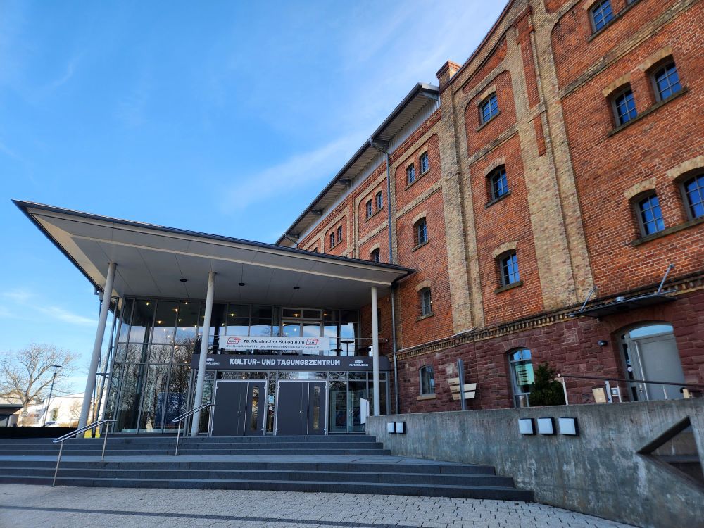 The "Alte Mälzerei" in Mosbach, where the conference is taking place. The building’s windows reflect the bright blue sky.