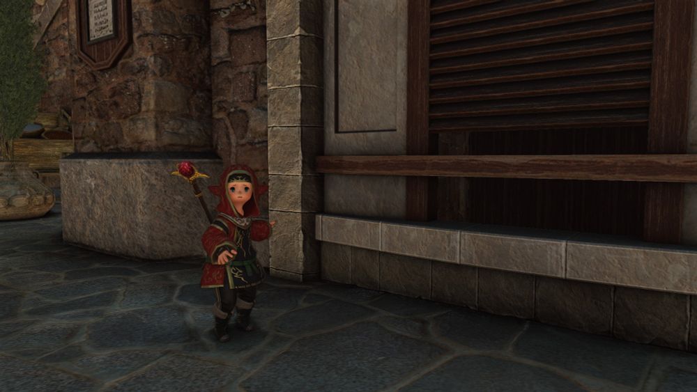 A Lalafell in an FFXI Vermilion Cloak panicking outside an auction house in Lower Jeuno