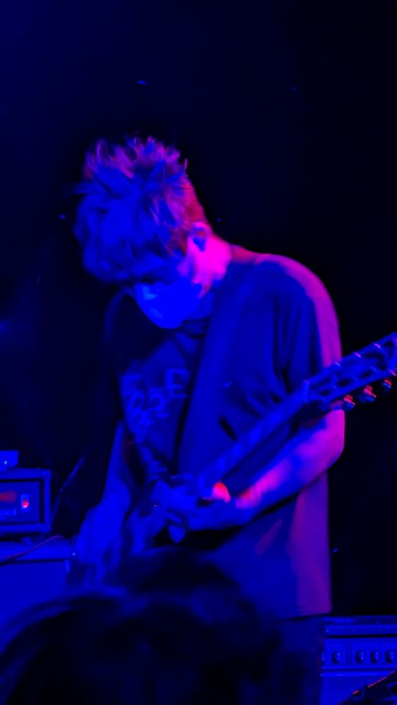 Ichiro Agata, guitarist of melt-banana shredding on his Gibson SG guitar, glowing in the stage light