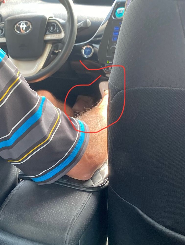 Pic of uber driver with bare foot on pedal