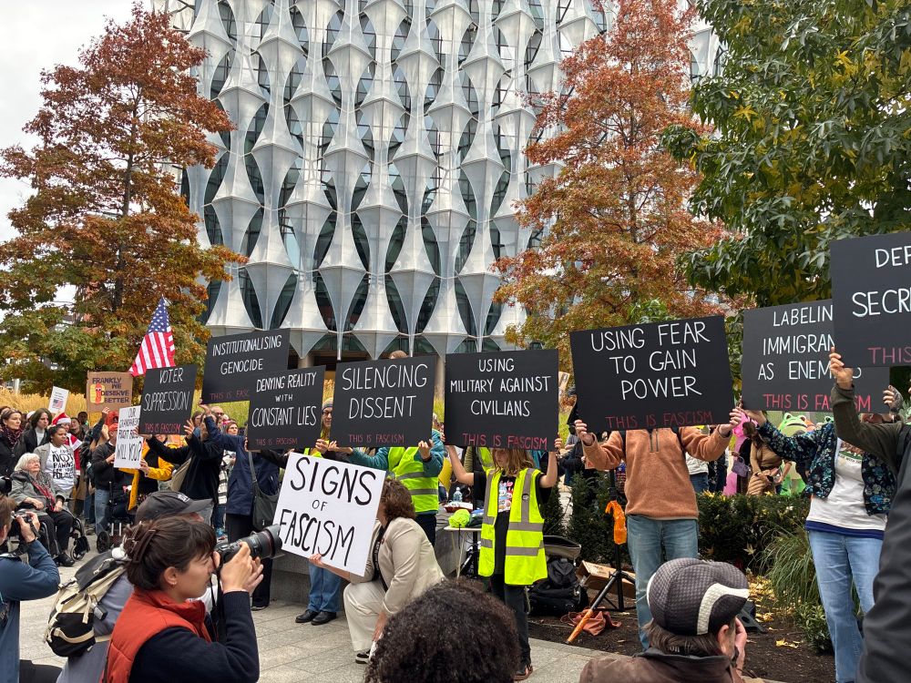 Signs of fascism: at the London protest, Human Rights Watch organized a series of placards with signs of fascism. Black signs, white letters, with content like using secret police, attacking immigrants, voter suppression, etc. 
