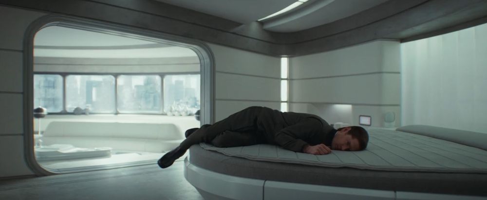 Syril from tv show Andor lies on his bed, looking defeated and over it 