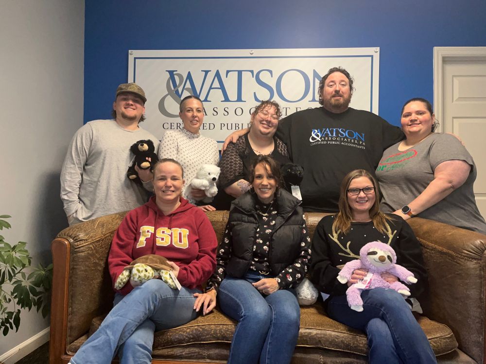 Group photo of the Watson & Associates team together at their office Christmas party. 

