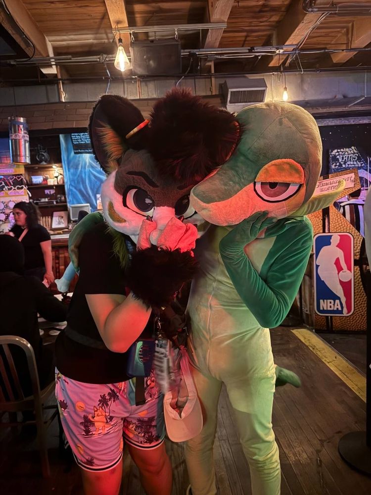 bay leaf possum and taji, a snivy fursuiter with a paw on their faces at a bar