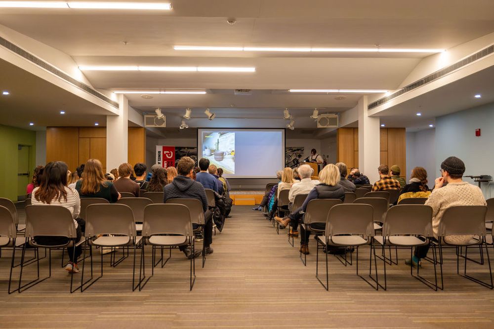Students, faculty and community members listen to a student presenter at the community conversation with design students on Saturday, February 8.