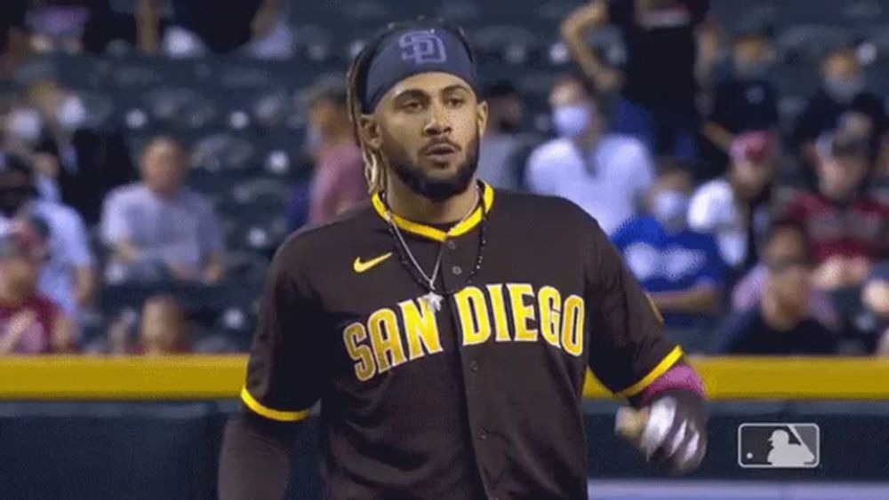 a man in a san diego baseball uniform is standing on a field .