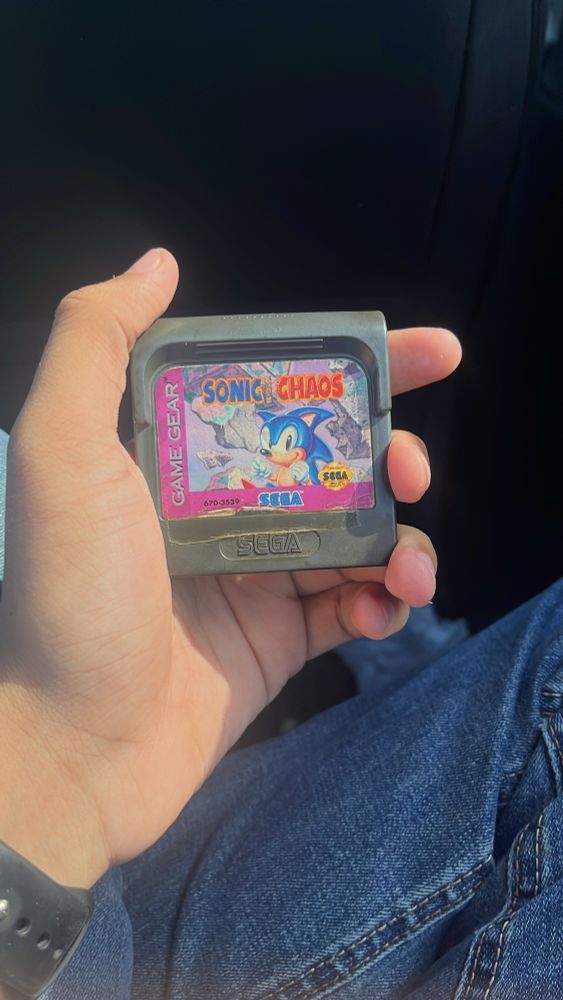 me holding 1 Game Gear cartridge labeled “Sonic Chaos”