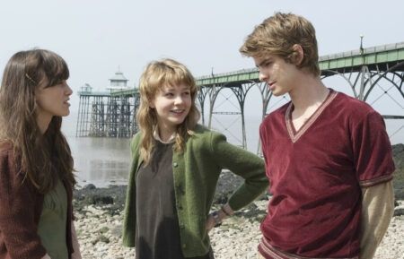 Never Let Me Go, 3 people (the terf sympathiser Keira Knightley and 2 others) on a rocky beach in front of a pier