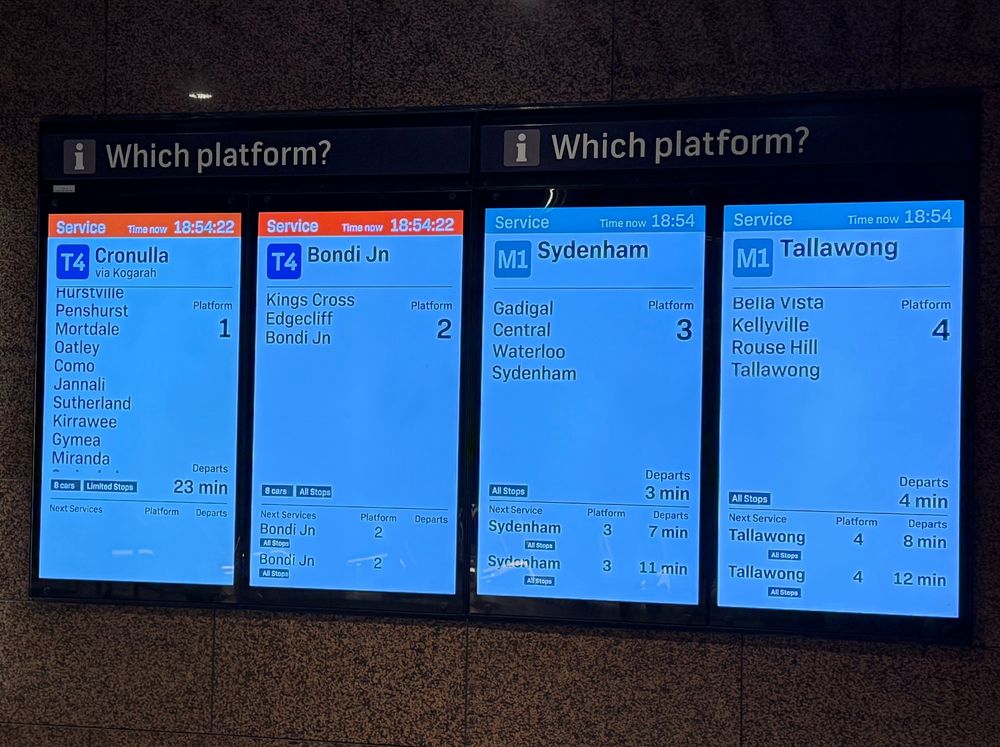 Indicator boards at Martin Place station showing Sydney Metro running every 4 minutes, Sydney Trains T4 mostly cancelled with only one train to Cronulla in 23 min