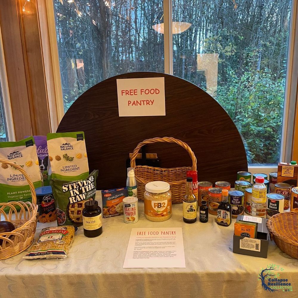 Image shows a free food pantry set up on a table, with a sign and instructions. 