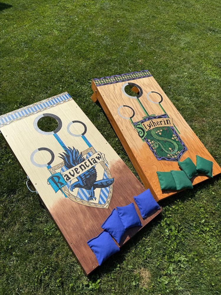 A cornhole set I made. One board has the Ravenclaw house crest and the other has Slytherin from the Harry Potter series. 