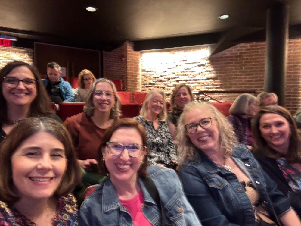 A group of eight women in a theatre