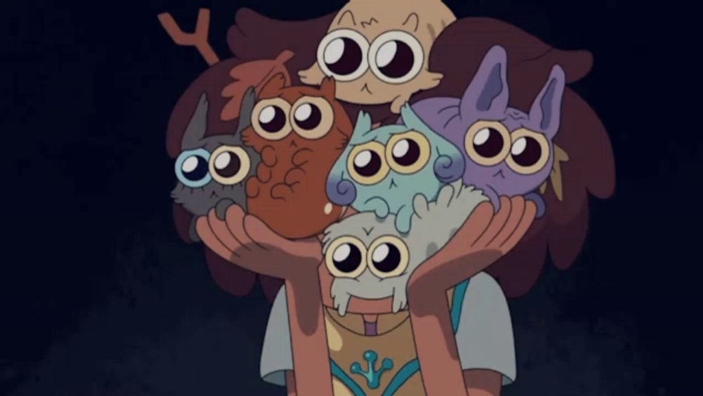 a cartoon character holding a bunch of owls on her head