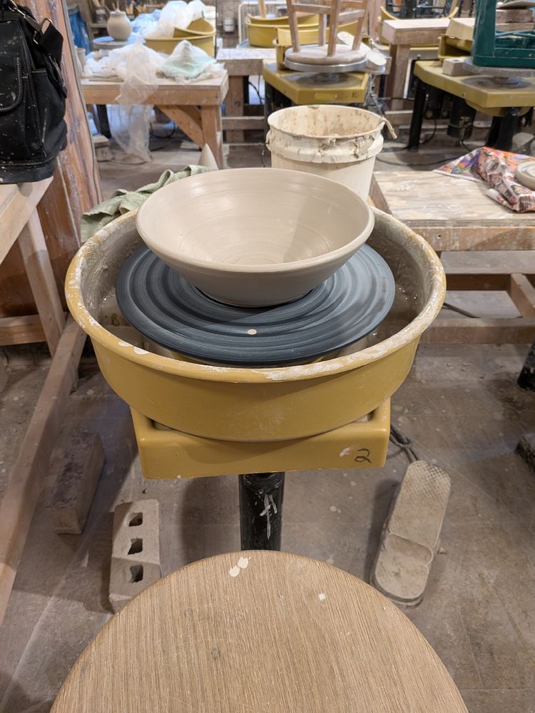 Greenware bowl on a pottery wheel.