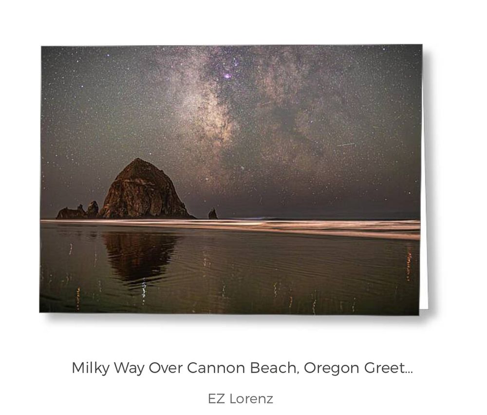 The Milky Way galaxy stretches across the night sky above Cannon Beach, Oregon. Haystack Rock is beautifully mirrored in the calm Pacific Ocean along with some stars in this long exposure, single image, taken on September 16th, 2025.