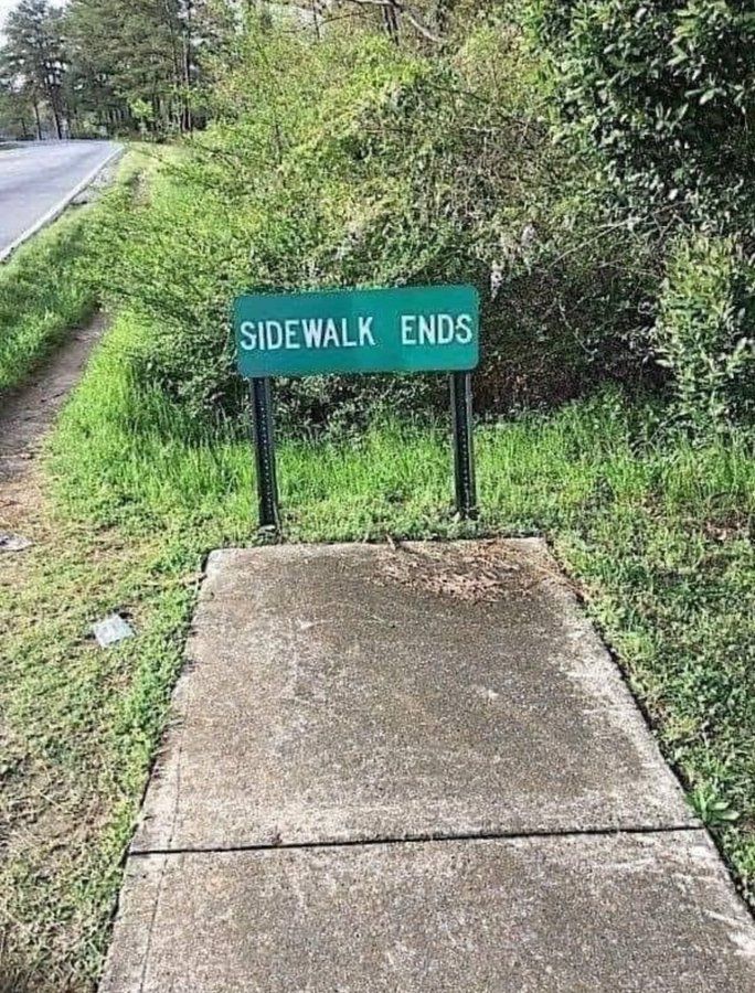 picture of the sidewalk ending with a sign "sidewalk ends" at the end