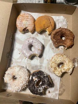 box full of bitten donuts 