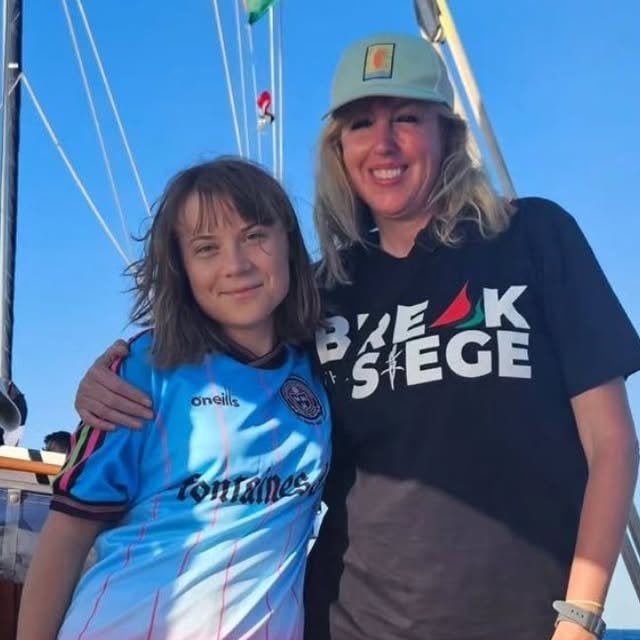 Greta Thunberg in a sky blue Bohemians FC away jersey with Fontaines DC as the sponsor