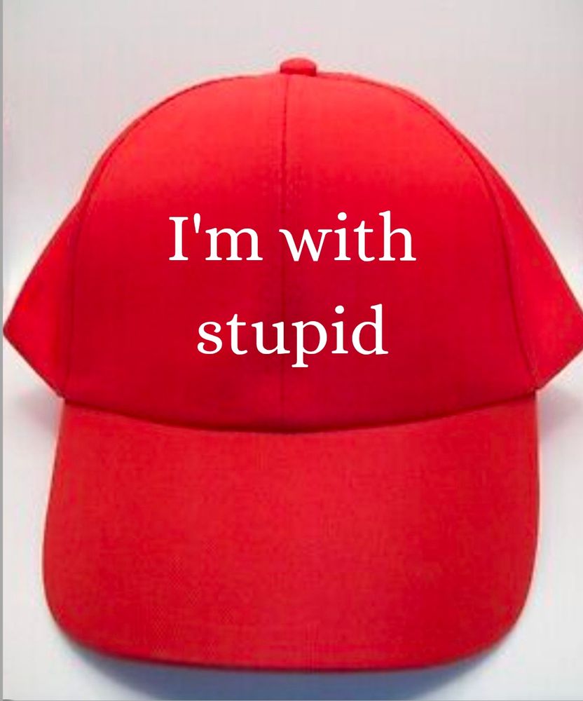 Red hat with white lettering. Lettering says "I'm with stupid" 