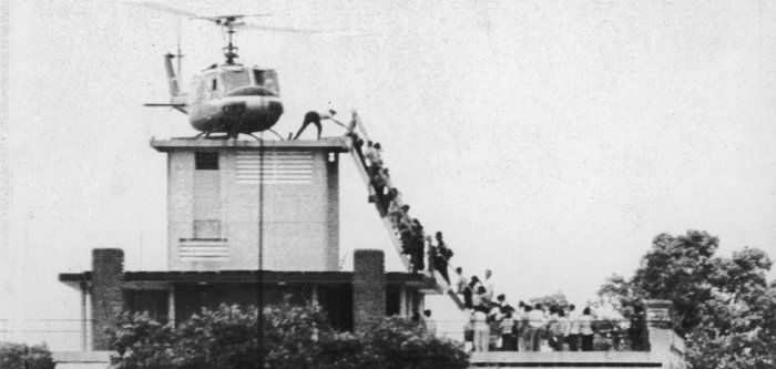 Photo of a line of desperate evacuees trying to board the last American helicopter out of Saigon, Vietnam.
