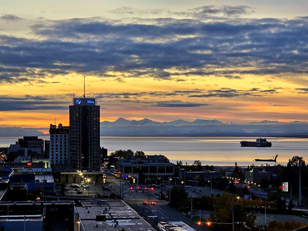 After completing it's weekly sojourn, a custom built for Alaska TOTE RO/RO ship departs the #PortOfAlaska shortly after sunset. Mt. Spurr is the taller peak nearest the Anchorage Hilton, the tall building on the left.