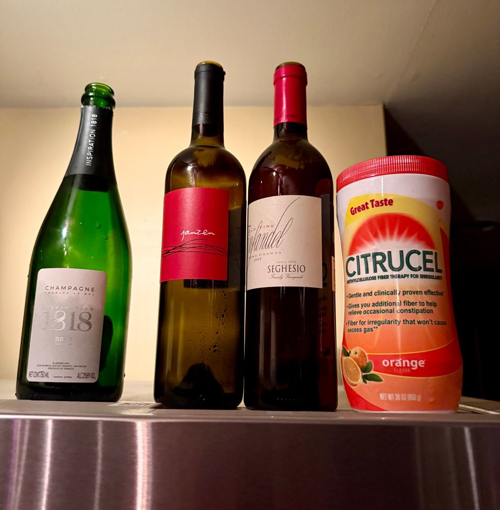 Bottles of wine and a bottle of Citrucel. 