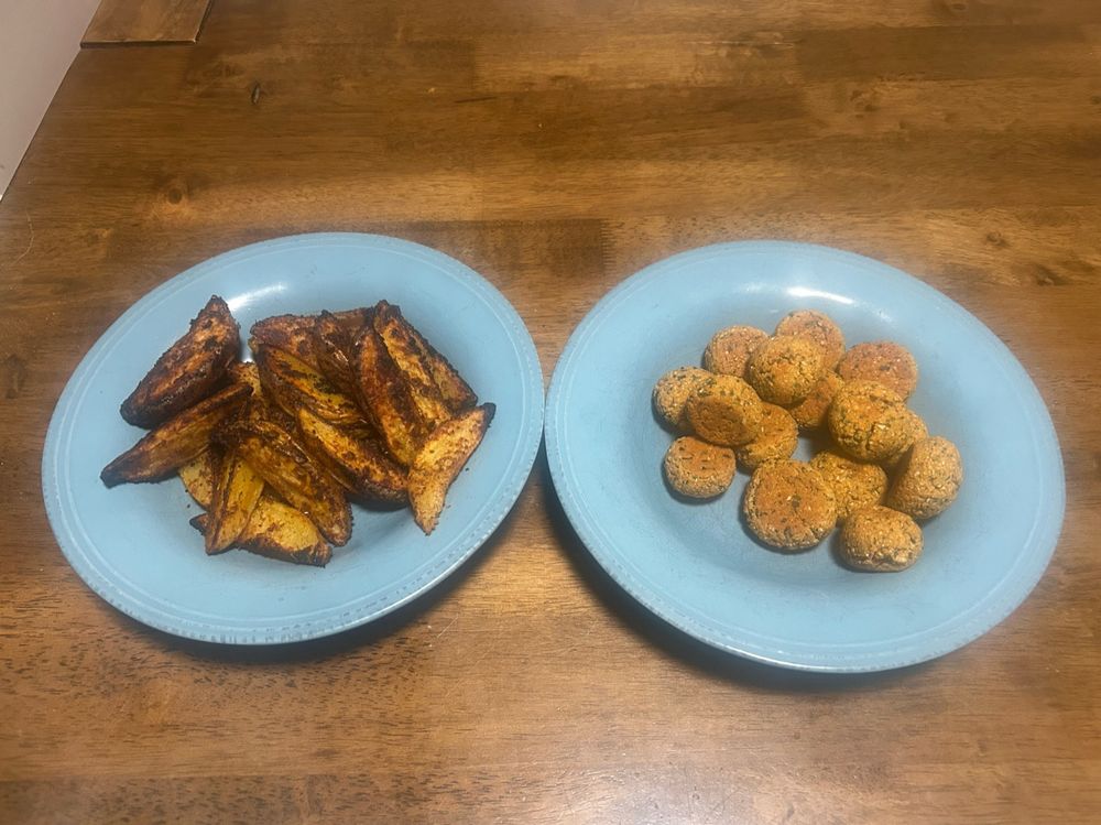 Yukon gold potatoes that are heavily seasoned and small falafel bites. (not pictured: tzatziki and pita bites) 