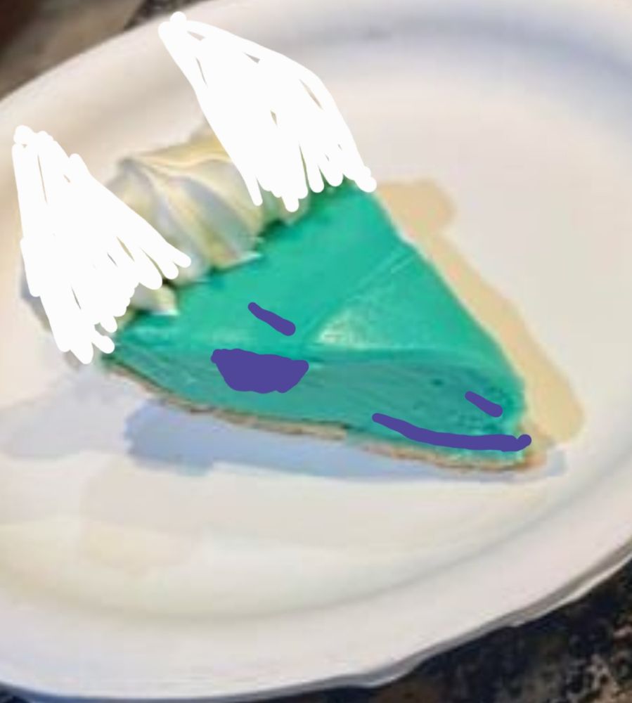 Piece of pie with a face crudely drawn on it to look like a sergal