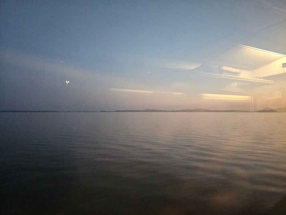 A photo of the Pacific ocean as seen from the car of a Cascades passenger train.