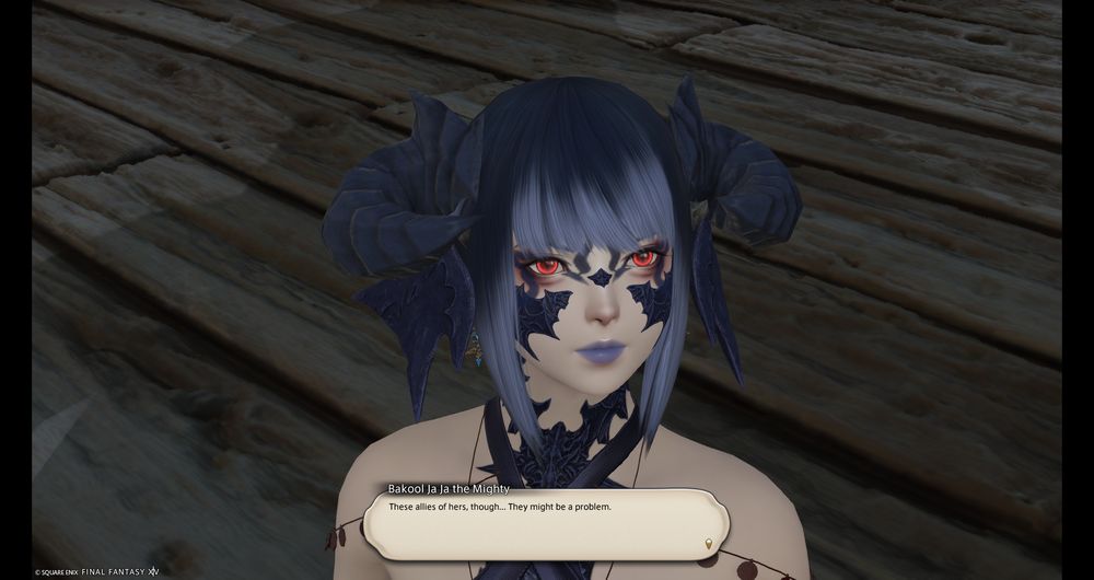 FFXIV screenshot of Dawntrail's dialogue, focused on the face of a pale woman with lizard-like features. She has dark blue scales and horns, with red eyes and blue lipstick.
