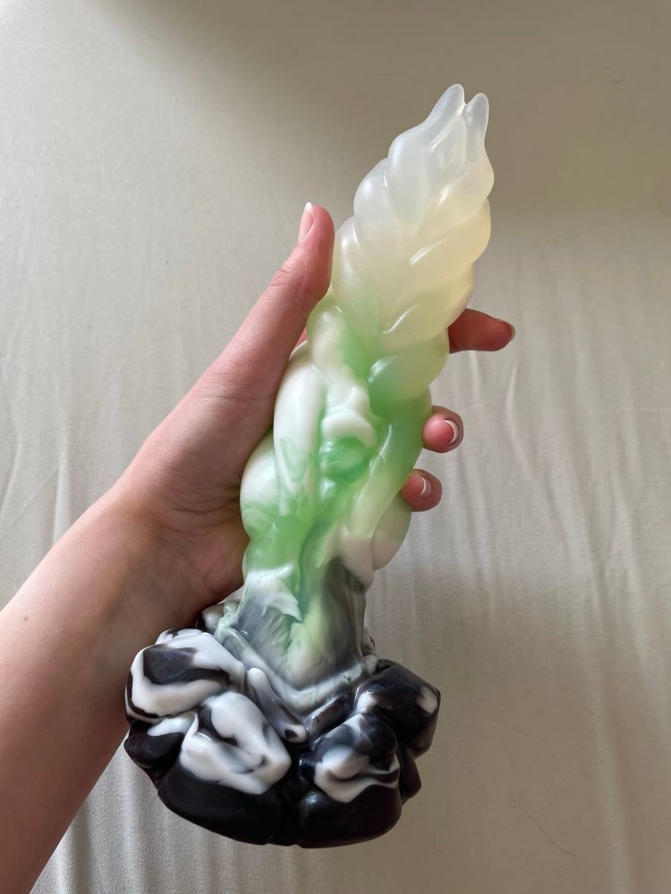 a near-clear to marbled green & while fantasy dildo with a black & white marbled base. model is Staghorn from TWH