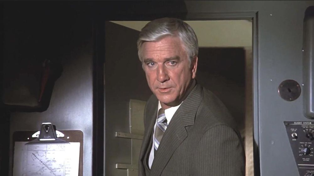 A still from Airplane where Leslie Nielson steps into the cockpit and says "I just want you to tell you, good luck. We're all counting on you."
