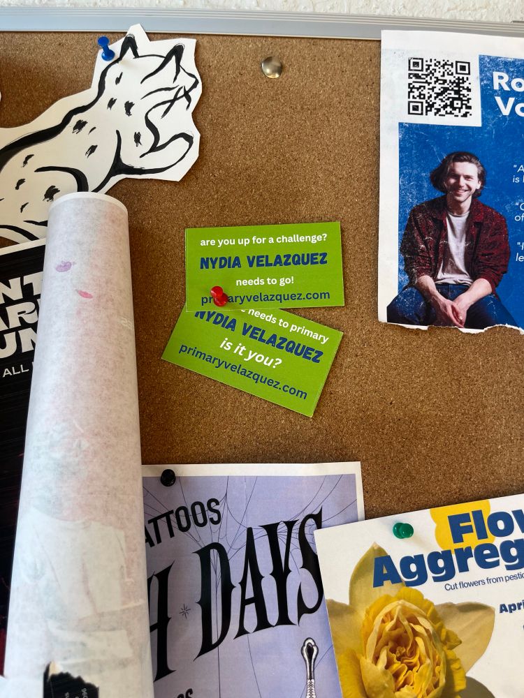 Primary Nydia Velazquez business cards tacked to a community bulletin board