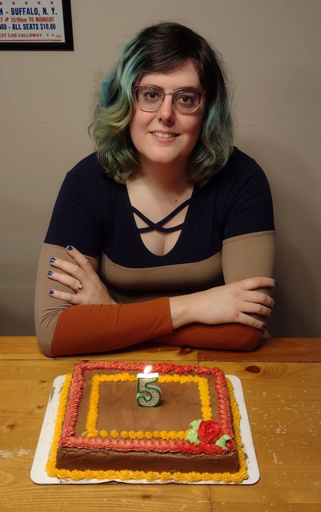Sarah sitting at the table, with a cake with a '5' candle in it. Oct 19, 2025.