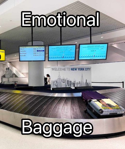 An airport luggage carousel with Steven He’s emotional damage meme  edited onto one of the bags. Text reads Emotional Baggage.