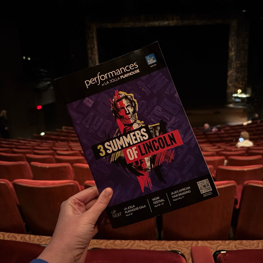 A program for 3 Summers of Lincoln, a World Premiere musical at La Jolla Playhouse, in front of the stage
