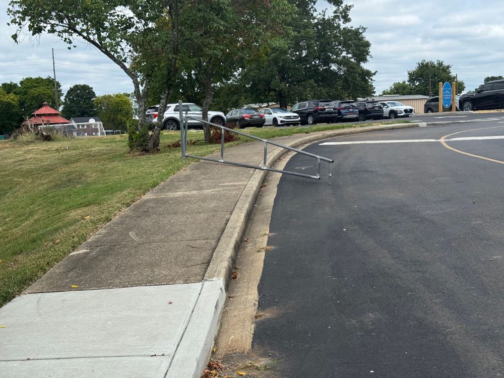 parking lot gate that blocks the sidewalk