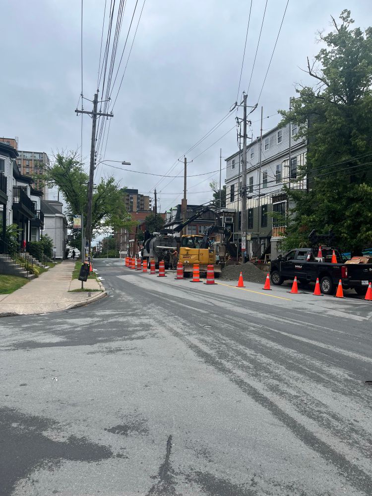 Morris St in Halifax looking east towards Queen. The eastbound lane has been closed and only the westbound lane is open. Traffic crews are directing traffic, but there is none in the photo.