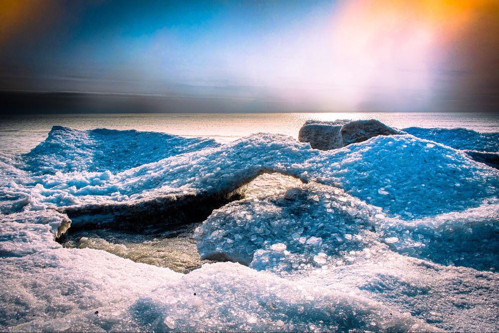 ice formations (including an ice bridge) on lake Ontario from last year with a colourful sky