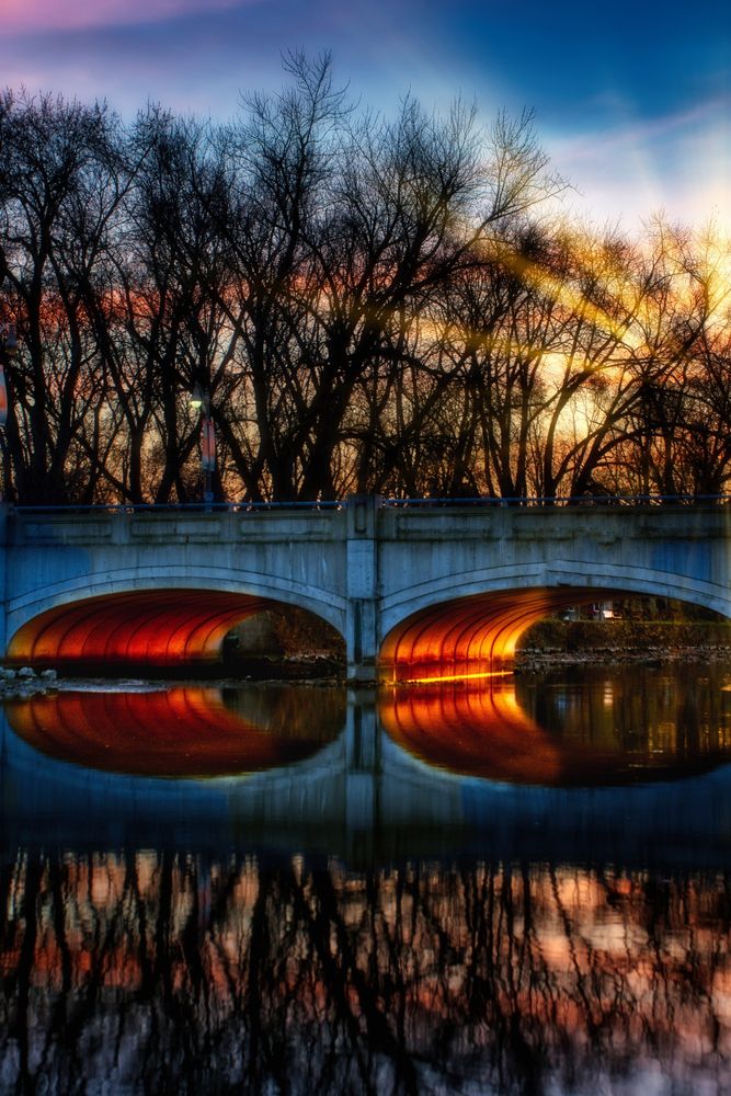 the underside of a bridge lit up by the setting sun