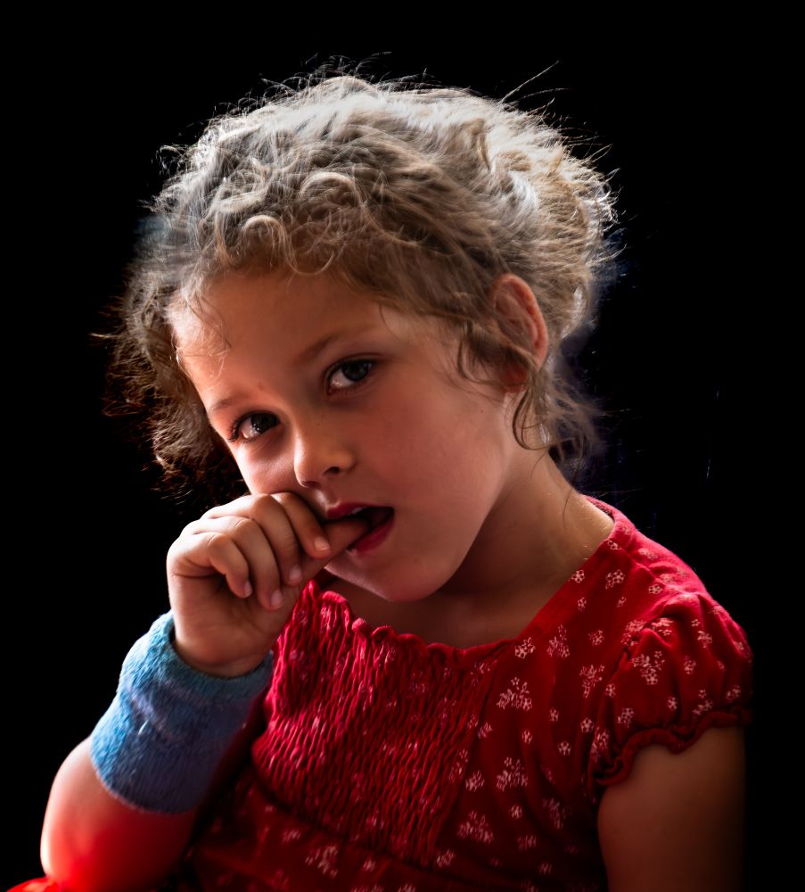 a young girl with a heart monitor on her wrist and a glint in her eyes.
