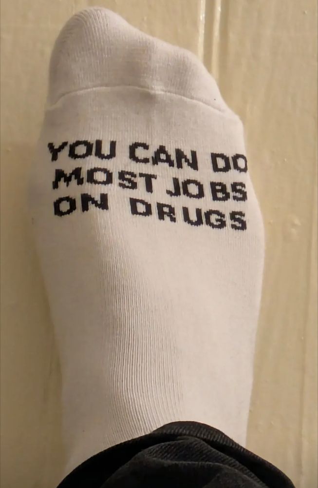 A white sport sock that says "you can do most jobs on drugs."