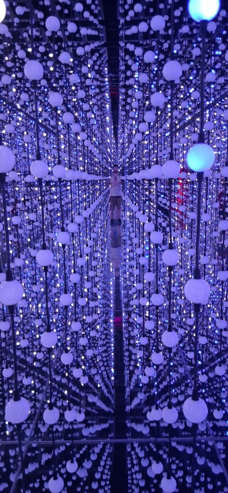 Yours truly in the room of lights (and mirrors!) at the Bubble Planet experience in Paris