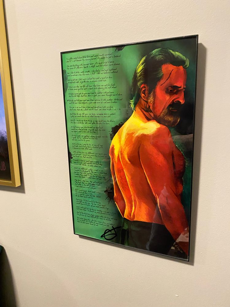 A picture hanging on a wall of a topless man with poetry written on it.