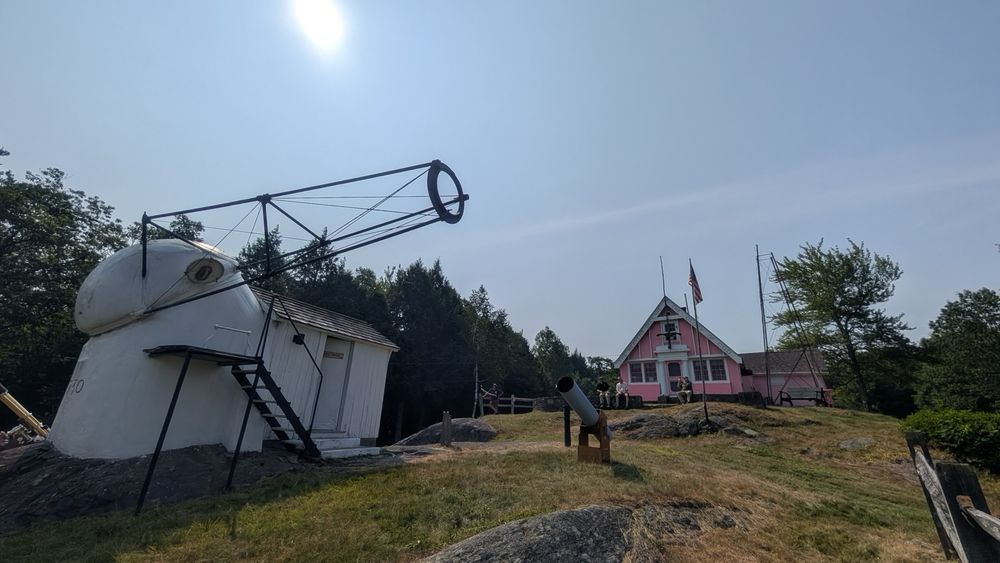 Breezy Hill with the Porter Observatory in the foreground and the pink Stellafane clubhouse in the background at the top of the hill.