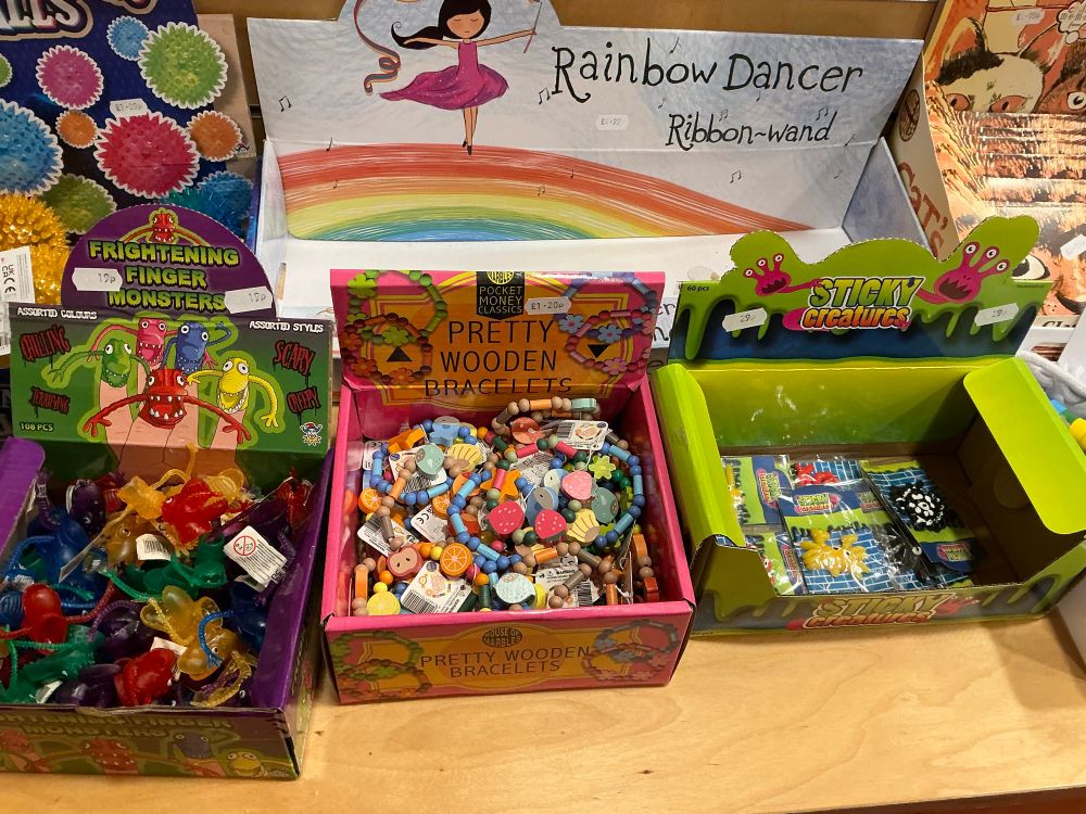 The frightening finger monsters are in dark shades of red, green, yellow, blue and purple. The wooden brackets are in pastel colours and as well as beads they have wooden charms. The sticky creatures are all individually wrapped and have multiple legs or tentacles. 