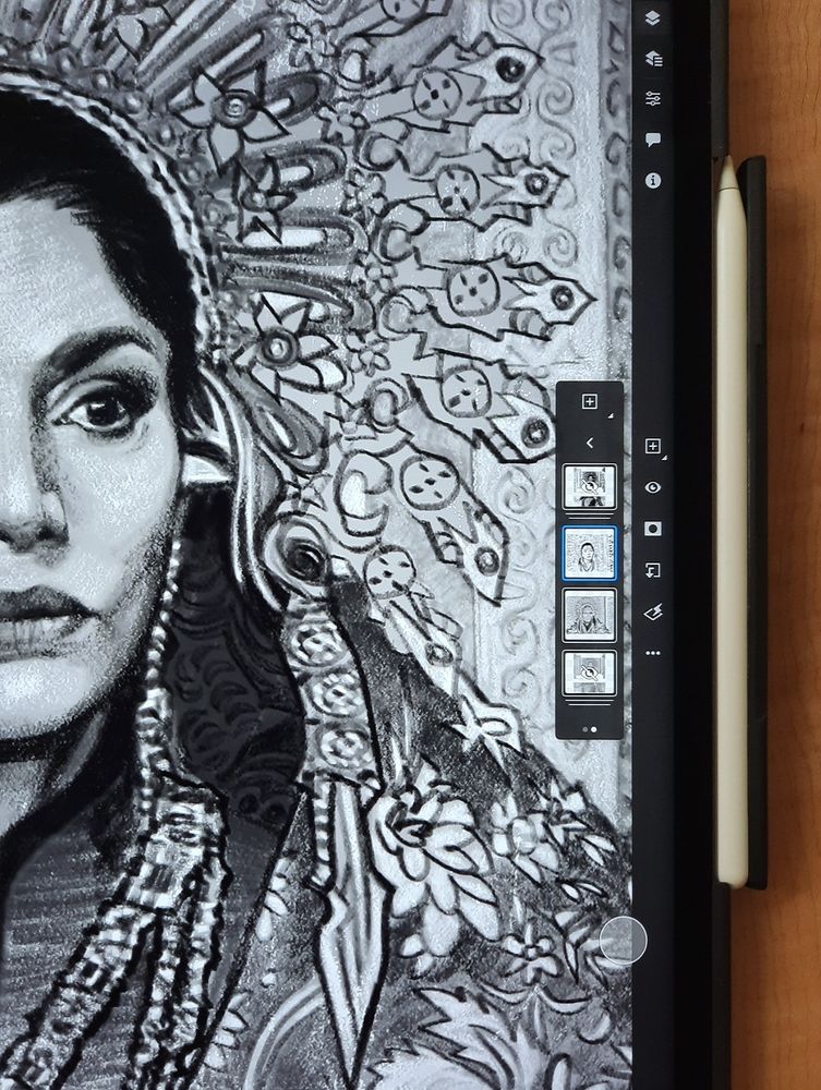 A close-up of Photoshop on an iPad with an Apple pencil at its left side, where we see a zoomed in and cropped black and white unfinished sketch of a still from the Wheel of Time season 3 showing Elaida Sedai (Shohreh Aghdashloo) sitting on the Amyrlin Seat in ostentatious Amyrlin regalia. She is looking at someone off camera unflinchingly, her lips pursed with disdain. We can only see the left side of her face, part of her sunburst crown, the raised shoulder of her garb, a long earring and part of a bejeweled necklace. On our right, there is a vertical bar with various Layer icons partly covering the loosely sketched columns of the Seat.