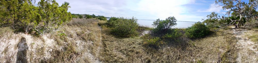 A panorama of a natural beach in a bay.