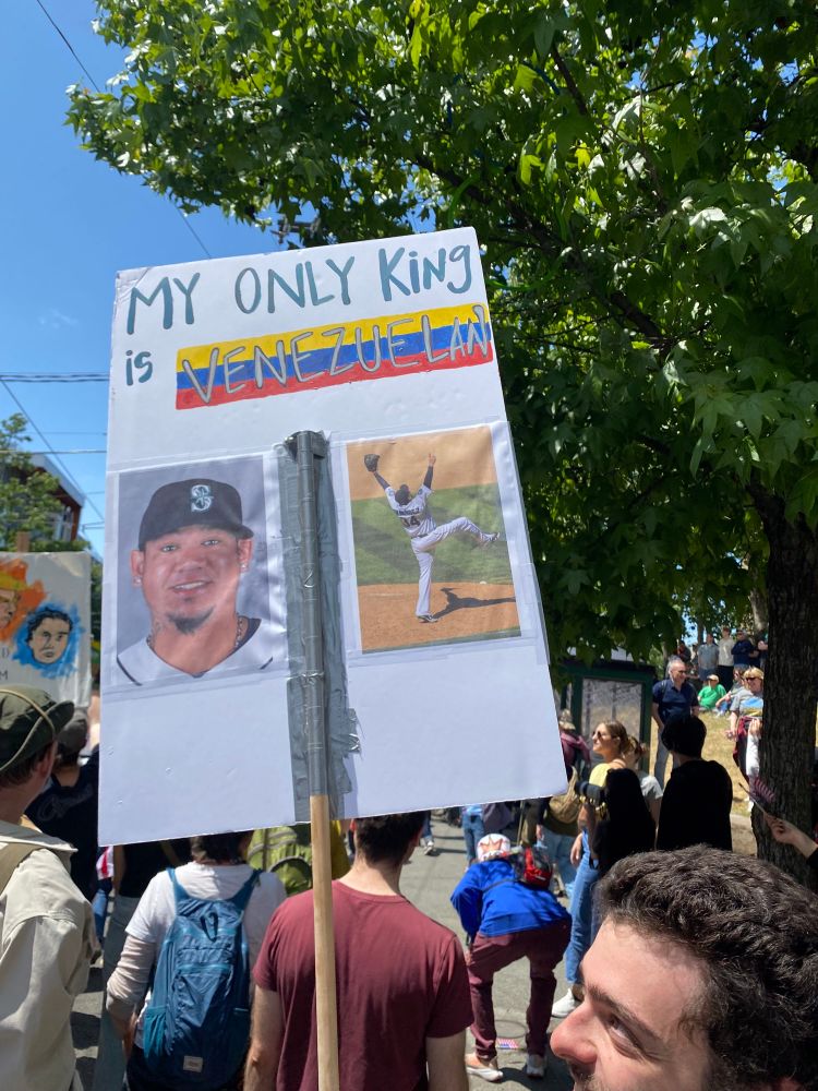 A sign with a picture of immigrant pitcher Félix Hérnandez celebrating his perfect game, with the words “my only king is Venezuelan” at the top